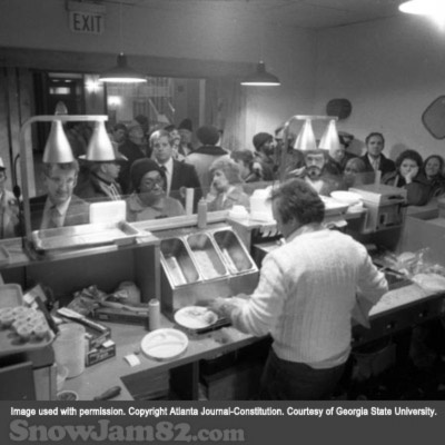 Employee attempts to serve an overcrowded restaurant of patrons during a snow storm - January 13, 1982 – Nick Arroyo