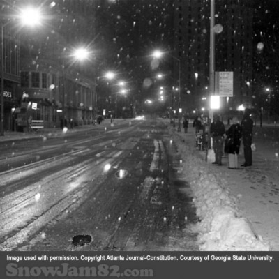 Commuters wait for public transportion as snow begins to fall during a storm near Woodruff Park - January 14, 1982 – AJC File
