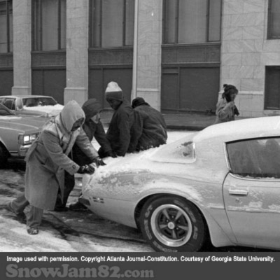 Motorists attempt to push stuck vehicles down an icy road during a snow storm in downtown Atlanta - January 12, 1982 – Dwight Ross Jr.