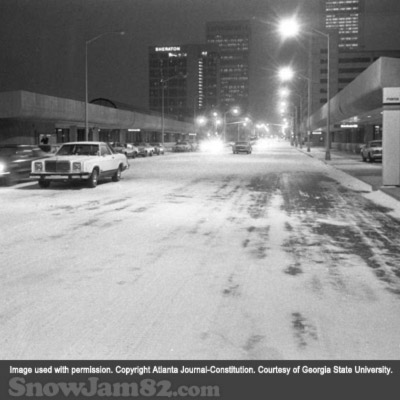 Snow begins to fall and cover the streets in front of the MARTA Civic Station during a snow storm - January 12, 1982 – AJC File