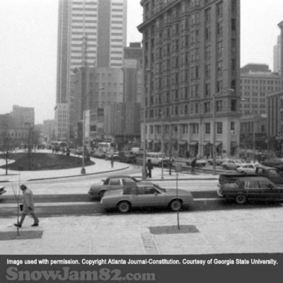 Workers and vehicles attempt to leave a congested downtown Atlanta near Woodruff Park as a snow storm approaches the area - January 12, 1982 – Dwight Ross Jr.