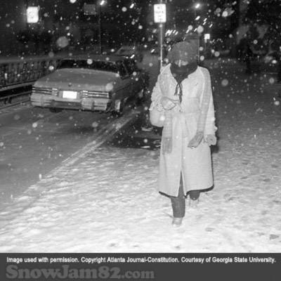 Bundled up pedestrian walking during a snow storm in downtown Atlanta - January 14, 1982 – AJC File