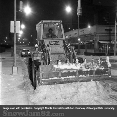 Snow plow driver working overnight to clear roadways during a snow storm - January 14, 1982 – AJC File
